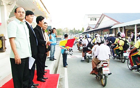 Officials send the students on their way with their new helmets.